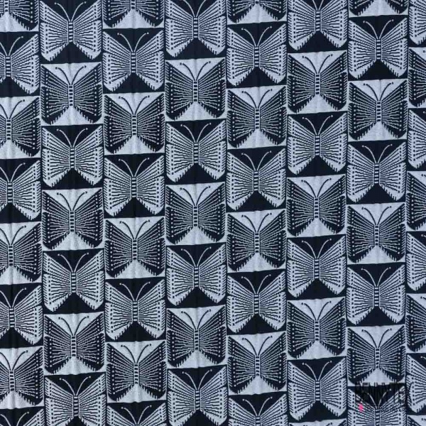 Jacquard imprimé papillon stylisé dans damier noir et blanc discret